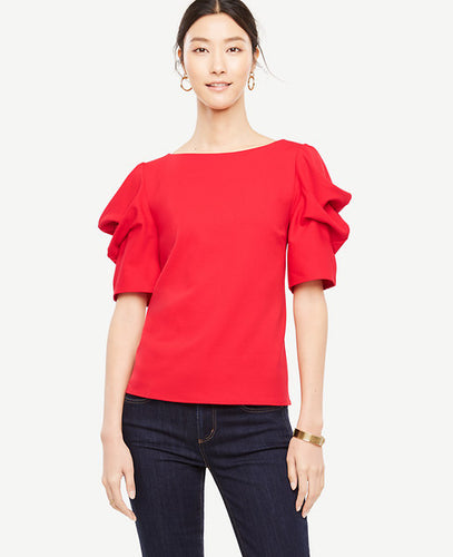 Artfully draped sleeves bring an architectural touch to this dramatically nuanced top. Jewel neck. Short tucked sleeves. Hidden back zipper with hook-and-eye closure. 25 1/4 long.