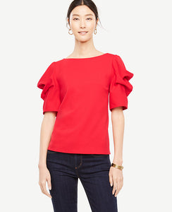 Artfully draped sleeves bring an architectural touch to this dramatically nuanced top. Jewel neck. Short tucked sleeves. Hidden back zipper with hook-and-eye closure. 25 1/4 long.