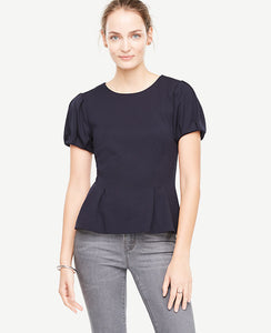 Bubble sleeves and precise pleats transform this structured crepe piece into a statement making must-have. Jewel neck. Short sleeves with pleated sleeve caps and cuffs. Inverted front waist pleats. Hidden back zipper with hook-and-eye closure. 25 long.