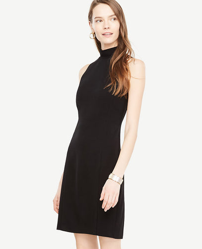 A circular back cutout turns our ruffle neck dress into a head-turning holiday hit. Ruffle stand collar. Sleeveless. Back cutout with button closure. Hidden back zipper. Back vent.