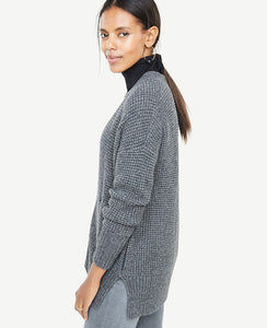 A textured waffle stitch adds warmth and refinement to our easy-to-layer open cardigan. Open front. Long sleeves. Drop shoulders. Vertical on-seam pockets. Side slits. Ribbed cuffs and hem. 27 long.