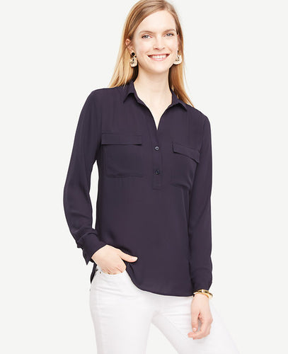 A modern popover silhouette adds instant ease to our camp shirt - an endlessly versatile piece in the season's most-coveted hues. Point collar. Long sleeves with button closure. Button front placket. Shirred forward shoulder seams. Front flap patch pockets. Back yoke with inverted pleat. Hi-lo shirttail hem. 25 1/2 front length; 26 3/4 back length.