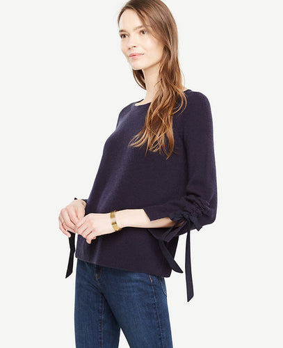 Meet your real-life uniform: this is Luxewear. Every day. Every wear. Our ruched tie sleeve sweater adds style and texture to your wardrobe - any day of the week. Jewel neck. Long raglan sleeves with slit cuffs and tunneled ties. 22 1/2 long.