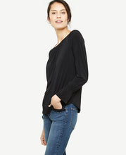 Ruffle cuffs bring modern refinement to this beautifully shirred knit top. Encased elastic shirred jewel neck. Long sleeves with encased elastic shirred cuffs. Back slit with hook-and-eye closure. Shirttail hem. 24 1/2 long.