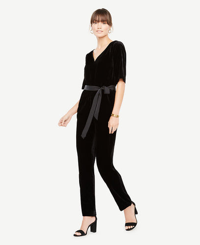 Go beyond the LBD this party season with our plush velvet jumpsuit - because best-dressed doesn't always mean a dress. V-neck. Short sleeves. Self tie belt. Tunneled elastic waistband. Front off-seam pockets. Hidden back zipper with hook-and-eye closure. Lined bodice. 29 1/2 inseam.