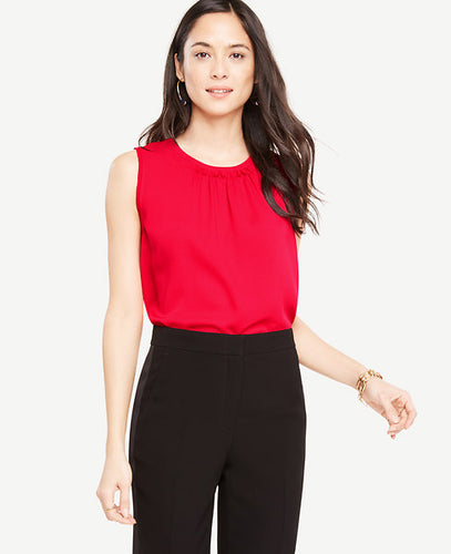 An artfully ruched neckline puts a modern twist on this wear-with-everything shell. Shirred jewel neck. Sleeveless. Back slit with button closure. 25 long.