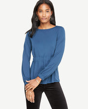 What we adore most about this matte jersey top is that it's so flattering - thanks to a cinched waist that gently flares out. Boatneck. Long sleeves with shirred tunnel encased elastic cuffs. Shirred tunnel encased elastic waistband. 23 long.