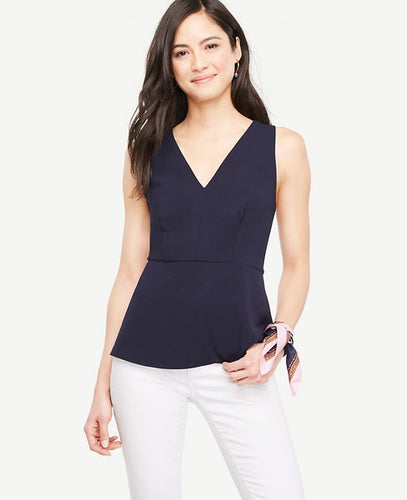 We've backed up this peplum with criss-cross straps and a ruffled hem for a look that's ready for wherever the day (or night) takes you. V-neck. Sleeveless. Cross back straps. Hidden back zipper with hook-and-eye closure. Ruffle back peplum. Lined. 14 1/2 back length.