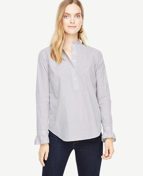 A ruffled collar and easy popover silhouette make this crisp poplin blouse one of our season's favorites. Ruffle stand collar. Long sleeves with button closure and ruffle cuffs. Button front placket. Shirred front shoulder seams. Back yoke with shirring beneath. Shirttail hem. 27 1/2 long.