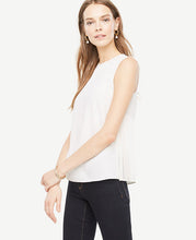 Chiffon side pleats add ease and refinement to this fluid shell. Jewel neck. Sleeveless. Chiffon pleated side panels. Back keyhole with button closure. 25 long.