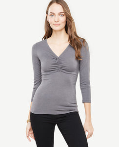 Meet your real-life uniform: this is Luxewear. Every day. Every wear. Romantic ruching takes this beautifully fitted V-neck from daytime to date night. V-neck. 3/4 sleeves. 25 1/4 long.