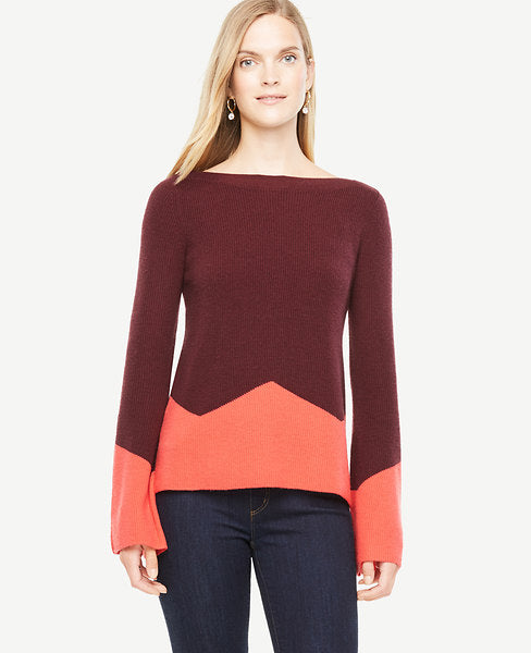 Elongated fluted sleeves make this colorblocked sweater perfect for cozying up to - weekday to weekend. Ribbed boatneck. Long sleeves. Side slits. 22 1/2 long.