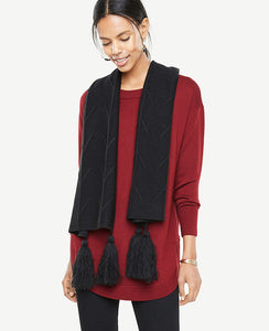 Pointelle detail and refined tassels make this soft knit scarf equal parts stylish and cozy. Tassels at ends. 15 x 83.