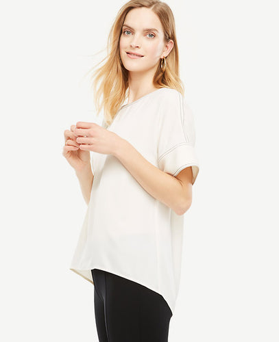 Meet your real-life uniform: this is Luxewear. Every day. Every wear. Contrast stitching and an elliptical hem take this defined tee a notch above. Jewel neck. Short sleeves. Hidden back zipper with hook-and-eye closure. Elliptical hem. 20 1/4 front length; 26 1/2 back length.