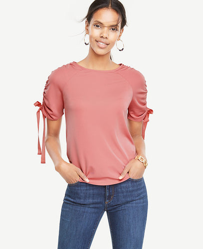 Ribbon-ruched sleeves put a sweet spin on this refined jersey top. Jewel neck. Short raglan sleeves with drawstring ties. 25 long.