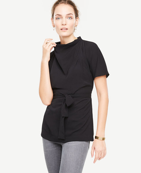 Our artfully draped mock tunic pulls it all together with a beautifully belted silhouette. Mock cowl neck with side pleats. Short sleeves. Self tie belt. Side slits. Back keyhole with hook-and-eye closure at back collar. 27 1/2 long.