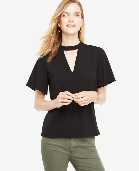 A strappy cutout front meets flowy flutter sleeves for a look that's sleek yet soft. Mock neck with V-front cutout. Short sleeves. Hidden back zipper with hook-and-eye closure. 24 long.