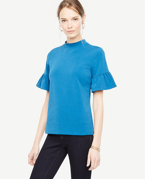 Our flare sleeve mock neck delivers just the right amount of flounce - in rich seasonal hues. Mock neck. Short sleeves with shirred flare cuffs. 25 long.