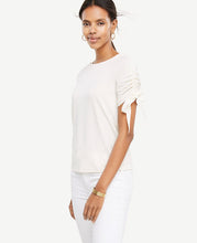 Ribbon-ruched sleeves put a sweet spin on this refined jersey top. Jewel neck. Short raglan sleeves with drawstring ties. 25 long.