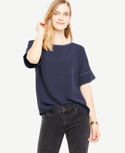 Meet your real-life uniform: this is Luxewear. Every day. Every wear. Contrast stitching and an elliptical hem take this defined tee a notch above. Jewel neck. Short sleeves. Hidden back zipper with hook-and-eye closure. Elliptical hem. 21 3/4 front length; 28 back length.