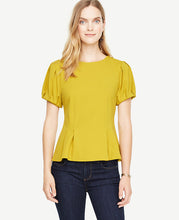 Bubble sleeves and precise pleats transform this structured crepe piece into a statement making must-have. Jewel neck. Short sleeves with pleated sleeve caps and cuffs. Inverted front waist pleats. Hidden back zipper with hook-and-eye closure. 25 long.