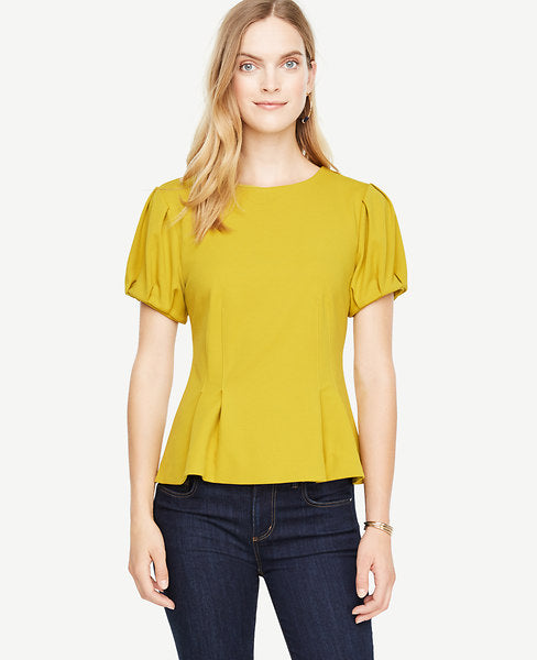 Bubble sleeves and precise pleats transform this structured crepe piece into a statement making must-have. Jewel neck. Short sleeves with pleated sleeve caps and cuffs. Inverted front waist pleats. Hidden back zipper with hook-and-eye closure. 25 long.