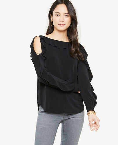 Romantic ruffles turn this shoulder baring style into a true statement-maker. Boatneck. Long sleeves with cuffs. 25 long.