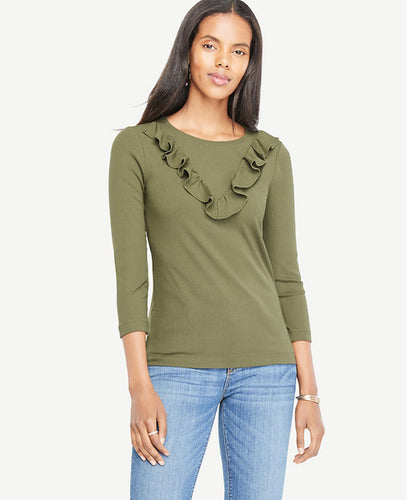 We gave this refined knit a bit of flounce with a V-shaped ruffle - and a flattering ribbed stitch. Jewel neck. 3/4 sleeves. 25 long.