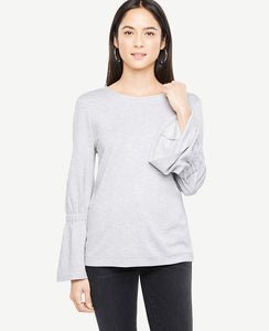 Bell sleeves ring in this soft and versatile knit with feminine flair. Jewel neck. Long sleeves with tunneled elasticized flare cuffs. 23 1/2 long.