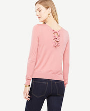 Back bow ties add a pretty twist to our extrafine merino wool sweater. Jewel neck. Long sleeves. Back self ties. Ribbed cuffs and hem. 23 1/2 long.