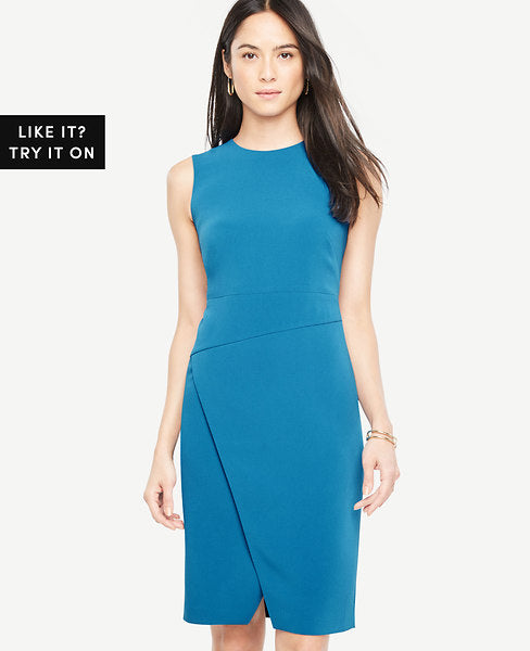 Asymmetric lines and a sleek overlapped skirt add architectural appeal to this impeccably fitted sheath. Jewel neck. Sleeveless. Hidden back zipper.