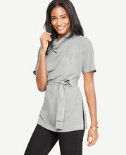 Our artfully draped mock tunic pulls it all together with a beautifully belted silhouette. Mock cowl neck with side pleats. Short sleeves. Self tie belt. Side slits. Back keyhole with hook-and-eye closure at back collar. 26 long.