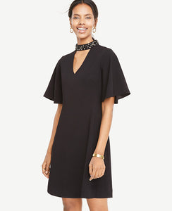 A brilliantly embellished choker neck transforms our flutter sleeve dress into a holiday gem. Beaded collar with back hook-and-eye closure. V-neck. Flutter sleeves. Hidden back zipper. Lined body. 19 from natural waist.