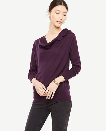 A bow-tied neckline brings an extra touch of pretty to this beautifully draped sweater. Drape neck with ties. Long sleeves. Ribbed cuffs and hem. 25 1/2 long.