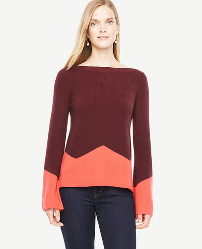 Elongated fluted sleeves make this colorblocked sweater perfect for cozying up to - weekday to weekend. Ribbed boatneck. Long sleeves. Side slits. 23 long.