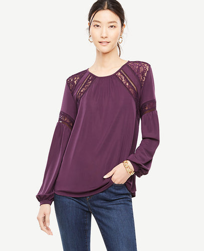 Intricate lace insets put a romantic spin on this softly-shirred jersey top. Shirred jewel neck. Long sleeves with shirred cuffs and button closure. Back slit with button closure. 26 long.