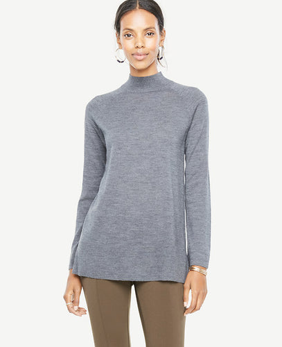 Meet your real-life uniform: this is Luxewear. Every day. Every wear. A flattering mock neck and longer length make this extrafine merino wool sweater a wardrobe must. Mock neck. Long raglan sleeves. Side slits. Ribbed neckline and hem. 28 1/2 long.