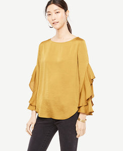 Cascading ruffle sleeves add modern fluidity to this romantically refined top. Boatneck. Long ruffle sleeves. Shirttail hem. 25 3/4 long.