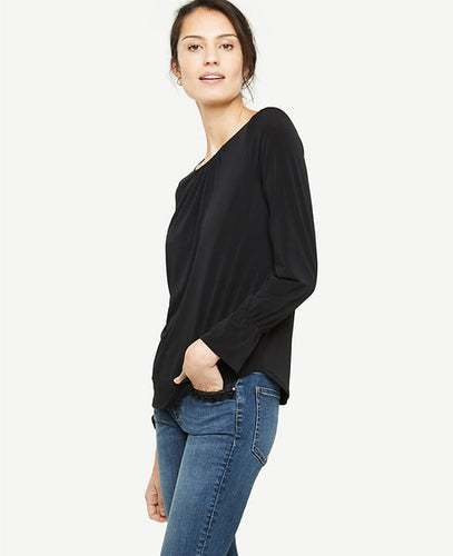 Ruffle cuffs bring modern refinement to this beautifully shirred knit top. Encased elastic shirred jewel neck. Long sleeves with encased elastic shirred cuffs. Back slit with hook-and-eye closure. Shirttail hem. 26 long.