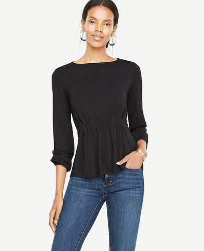 What we adore most about this matte jersey top is that it's so flattering - thanks to a cinched waist that gently flares out. Boatneck. Long sleeves with shirred tunnel encased elastic cuffs. Shirred tunnel encased elastic waistband. 24 long.