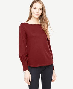 We've paired blouson sleeves with sleek wide cuffs for a modern twist on femininity. Boatneck. Long sleeves with wide cuffs. Shirttail hem. 25 long.